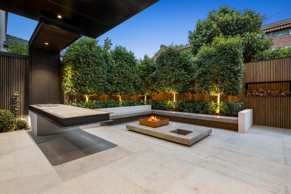 Garden lounge with a fire pit, seating and planted borders